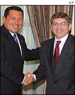 Venezuelan President Hugo Chavez, left, with Cesar Gaviria
