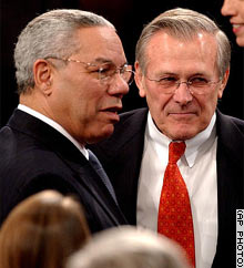 U.S. Secretary of State Colin Powell, left, and Secretary of Defense Donald Rumsfeld talk on the floor of the House on Tuesday evening.