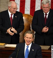 Vice President Dick Cheney, left, and House Speaker Dennis Hastert applaud with members of the House and Senate as President Bush prepares to speak.